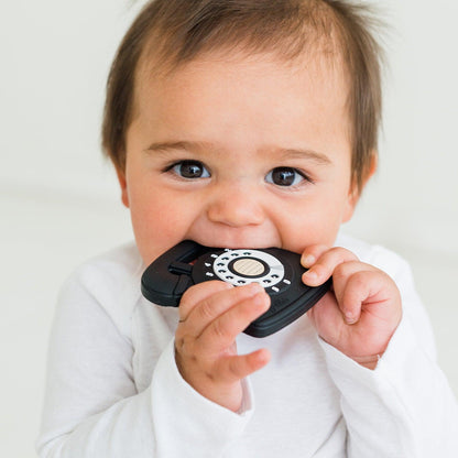 Baby chewing on black silicone rotary phone-Winchester Creek Farm