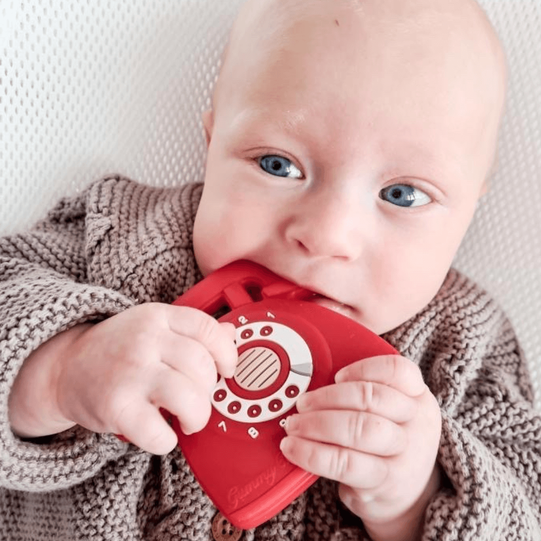 Baby chewing on red silicone rotary teether-Winchester Creek Farm